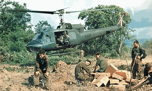 Phuoc Tuy Province, South Vietnam, November 11 1967. Soldiers from Support Company, 7th Battalion, The Royal Australian Regiment (7RAR), dodge the downdraft of an Iroquois helicopter during Operation Santa Fe. (Commonwealth of Australia)